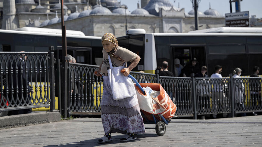 An elderly woman pulls a trolley ahead of the May 28 Turkey's presidential run-off, Istanbul, Turkey, May 22, 2023.